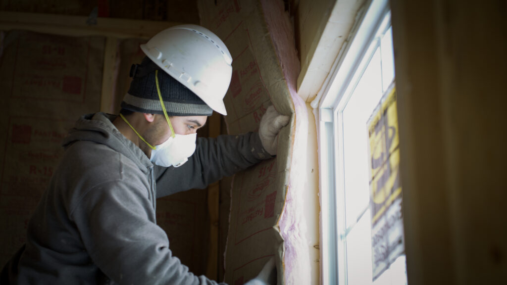 technician installing batt insulation